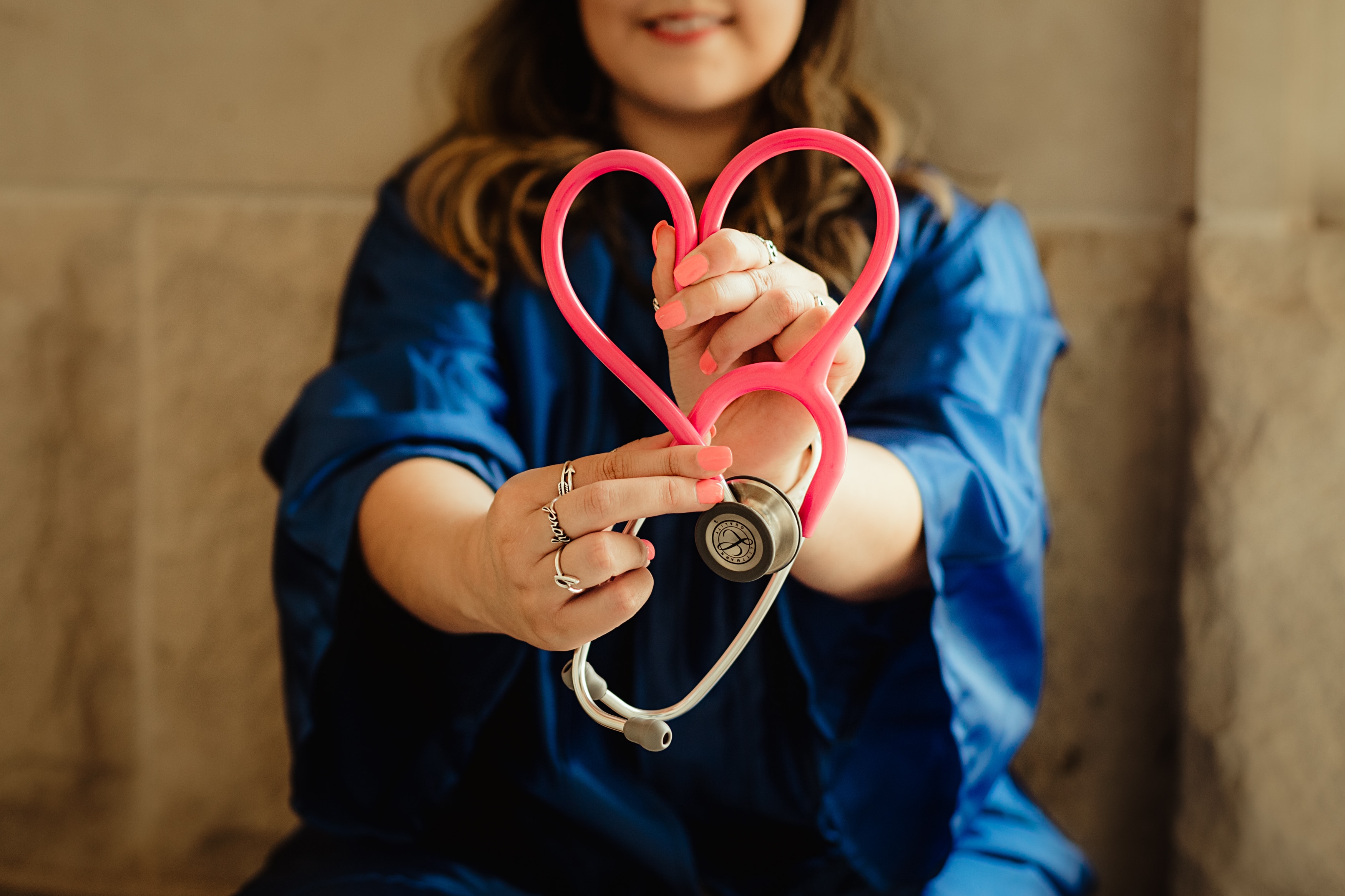 nurse with stethoscope looped into a heart